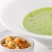 Delicate puree soup with fresh broccoli and melted cheese